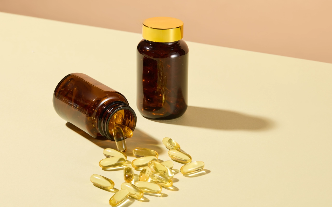 A table with two bottles and some pills on it