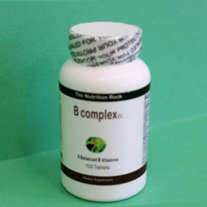 B Complex vitamin bottle on green background.