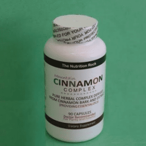 Cinnamon Complex supplement bottle on green background.