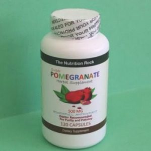 Pomegranate herbal supplement bottle on green background.