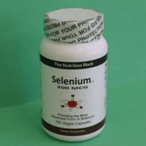 Selenium dietary supplement bottle on green background.