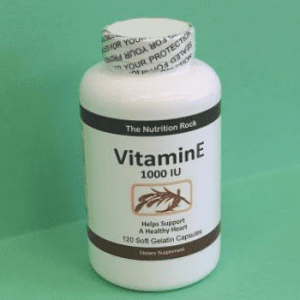 Vitamin E supplement bottle on green background.