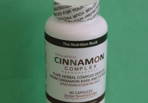 Cinnamon Complex supplement bottle on green background.
