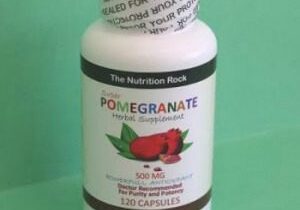 Pomegranate herbal supplement bottle on green background.